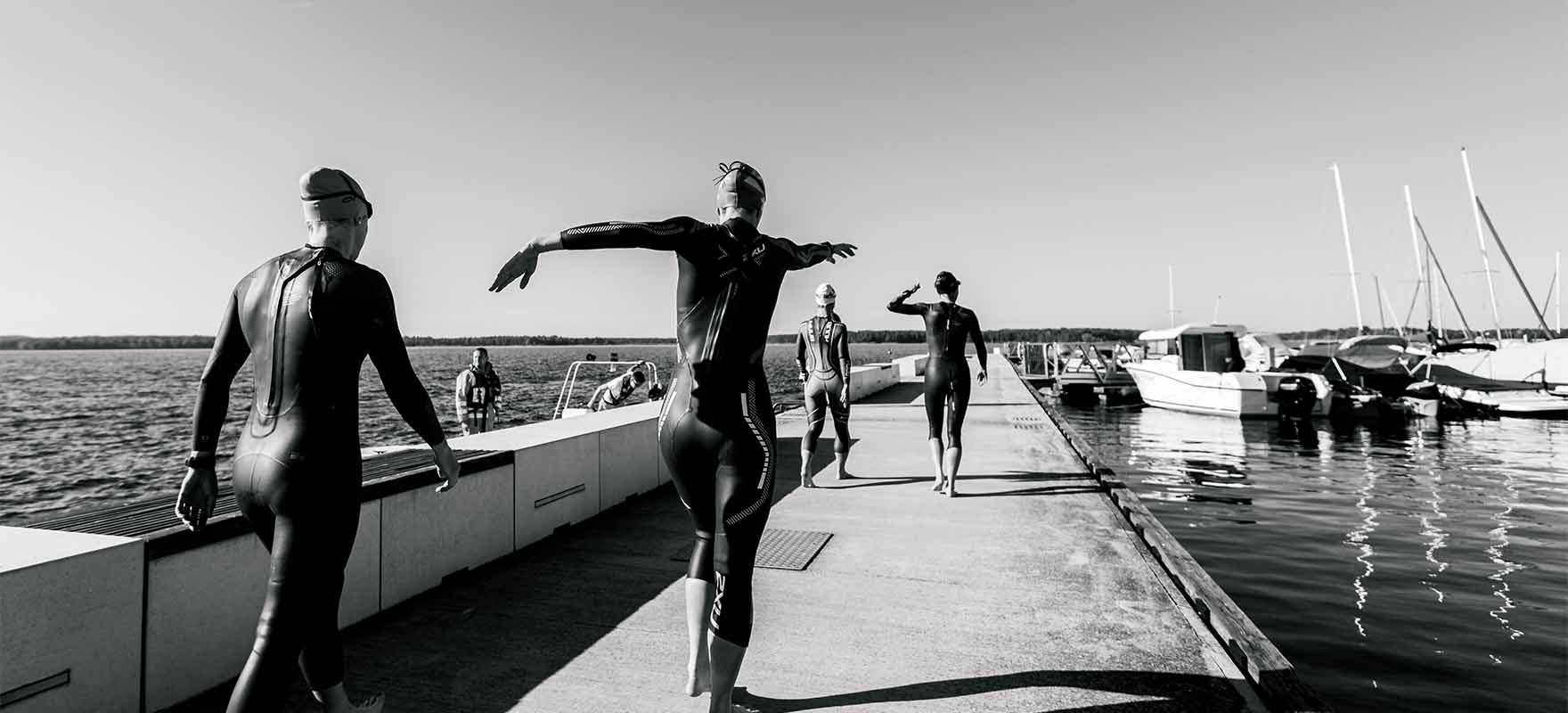 triathletes stretching on the deck
