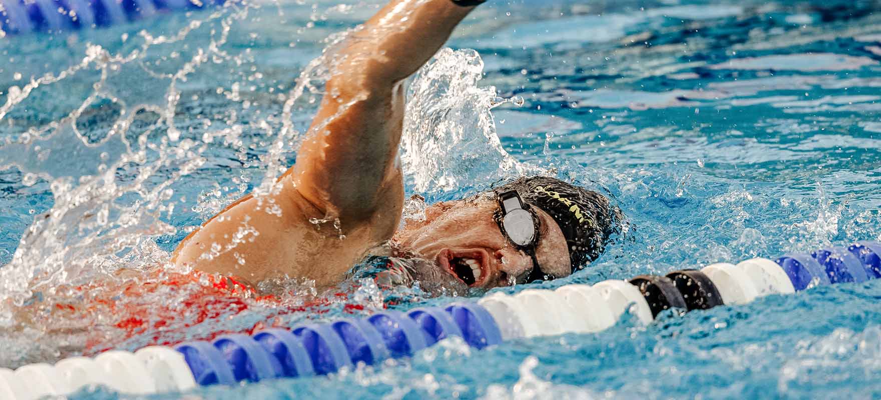 An athlete side breathing while swimming in the pool