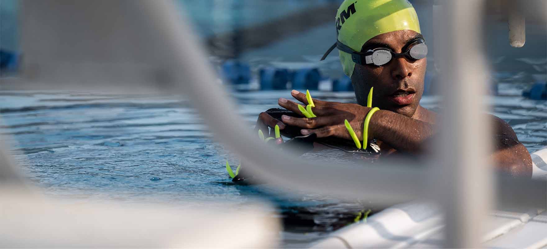 triathlete wearing a FORM swim cap and goggles in the pool