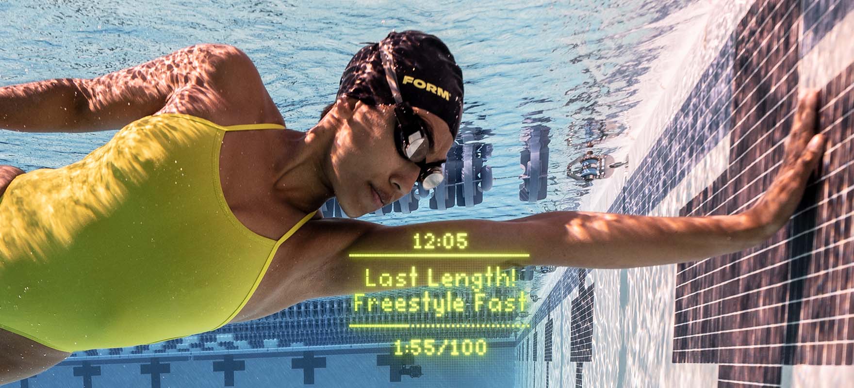 A swimmer with her swim goggles displaying real-time metrics