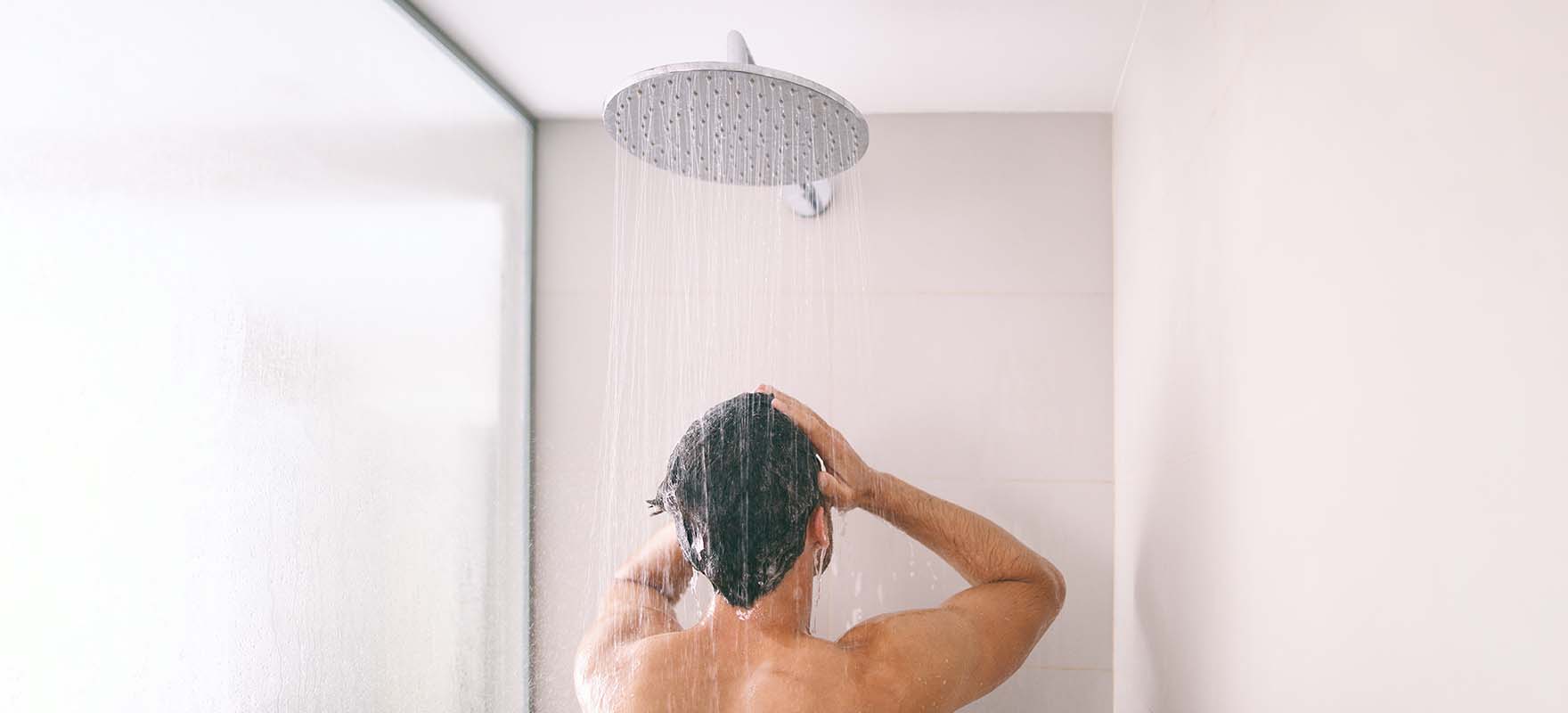 swimmer showering to clean chlorine out of their hair