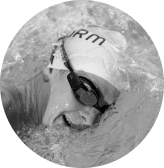 A lady swimming with FORM swim goggles