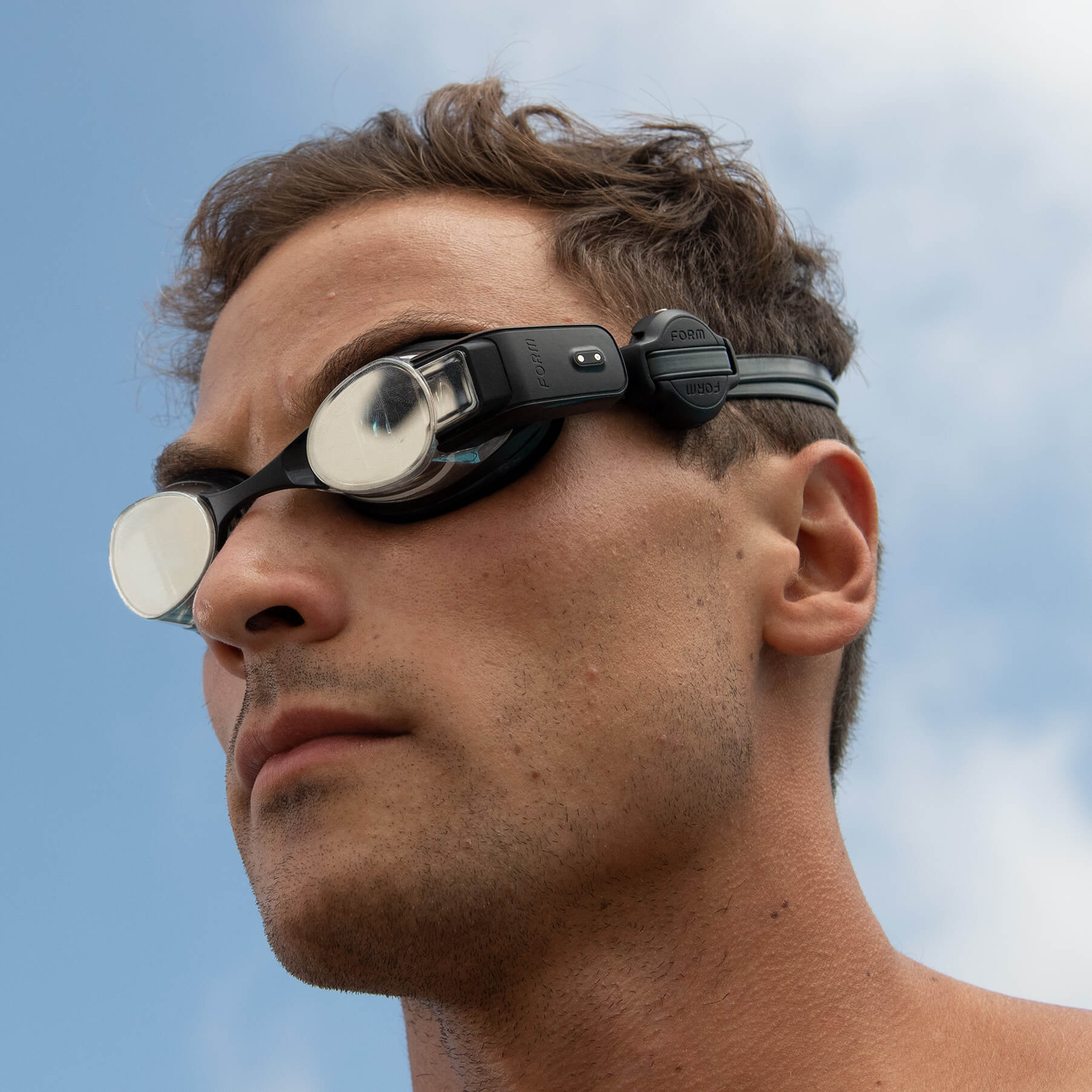 Man wearing swimming goggles with heart rate monitor attached